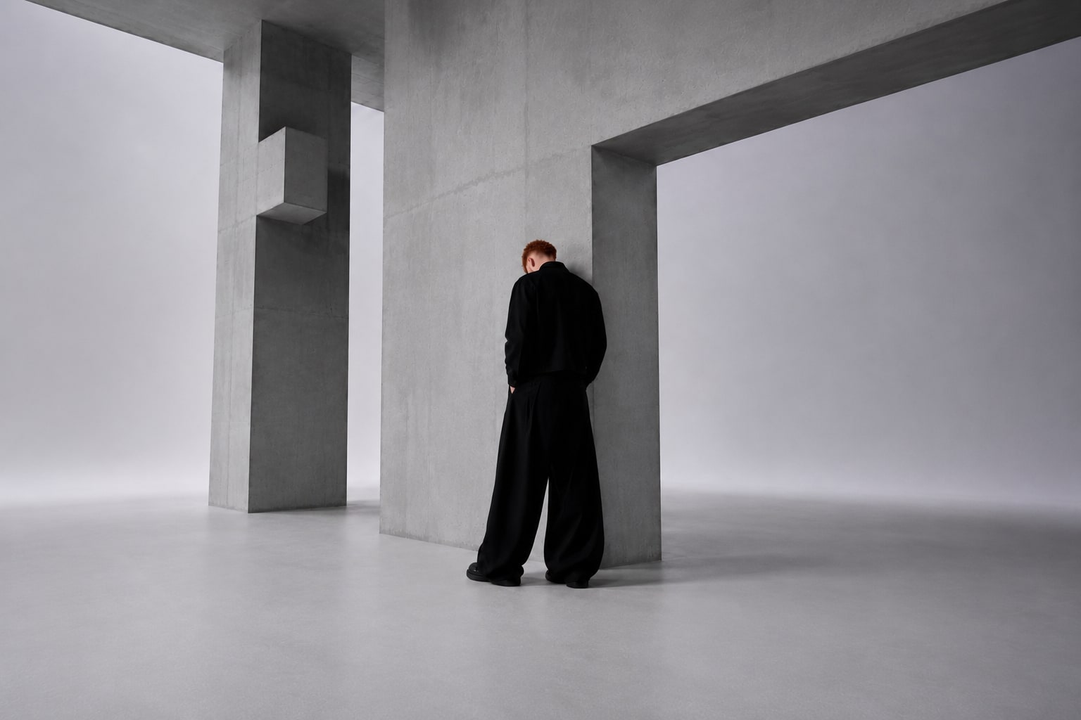 Walid Eskandarani in black, in an understated architectural setting